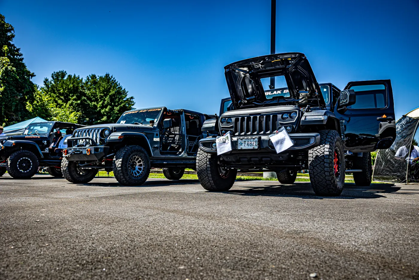 Rows of lifted Jeeps and trucks lined up at the 2025 Apple Off Road Truck & Jeep Show.